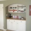 We built a custom wet bar unit on an adjacent wall in a matching style and white finish