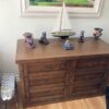 Decorated view of six drawer Mission style oak media cabinet