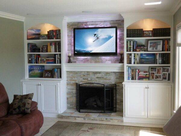 Custom built-in wall unit surrounding fireplace in white