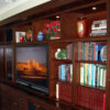 Angled view of built-in bookcases, media cabinet, and lighted display.