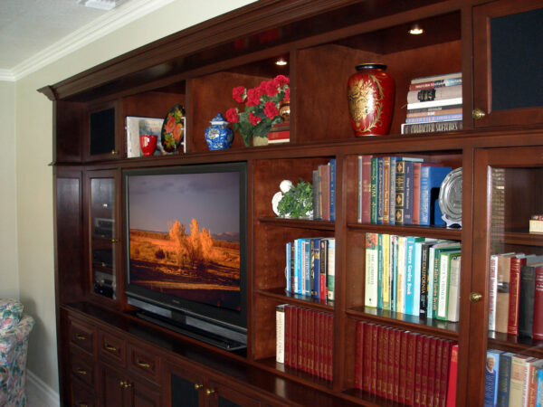 Angled view of built-in bookcases, media cabinet, and lighted display.