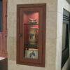 Lighted display cabinet in fireplace cubby to match built-in wall unit