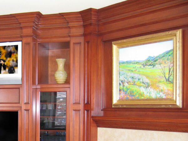 Traditionally styled crown molding with stunning detail included paneling above the fireplace and custom mantle.