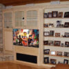 This built-in wall unit was upgraded with a structural TV back wall, heavy-duty, double-arm, pull-out bracket, and a decorative frame out panel to match the styling of the furniture.