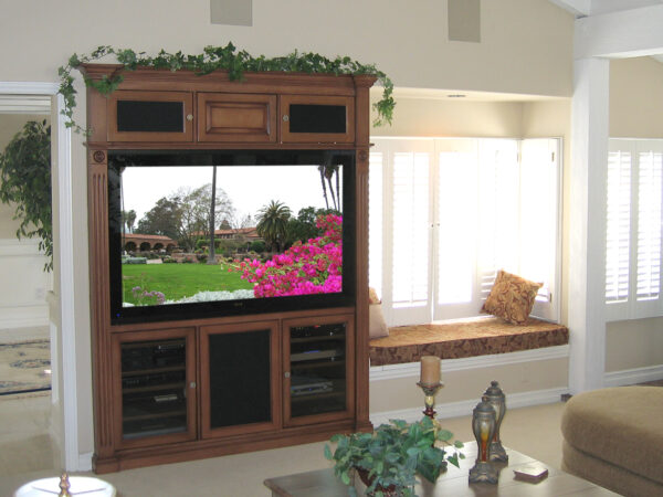 Beautiful built-in home theater armoire next to window seat