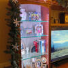 A close-up of the display cabinets showing the glass shelves, LED lights, and designer back panels.