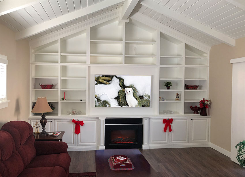 Large white built-in custom cabinets on wall with vaulted ceilings.